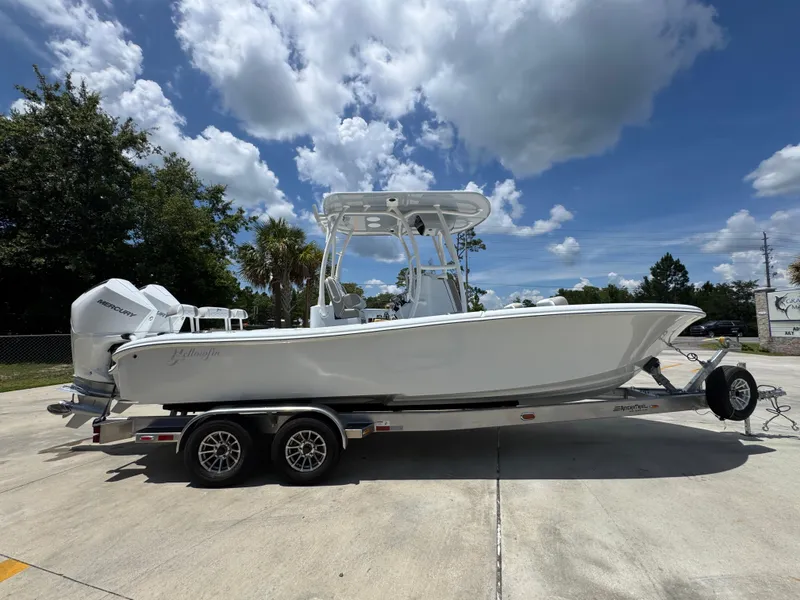 Slide: The Image of 2026 Yellowfin 26 Hybrid boat on trailer under a partly cloudy sky. - 10