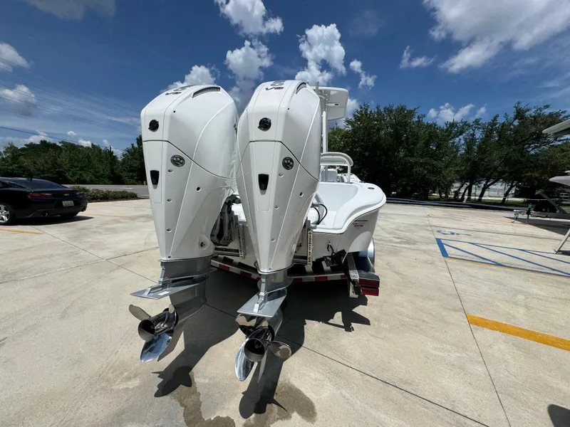 Slide: The Image of 2026 Yellowfin 26 Hybrid boat with dual outboard engines on a trailer. - 13