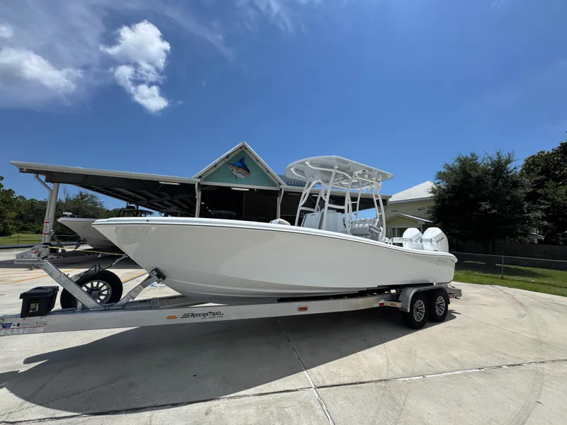 Slide: The Image of 2026 Yellowfin 26 Hybrid boat on trailer under clear blue sky. - 2