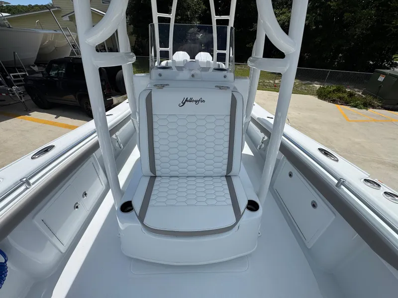 Slide: The Image of 2026 Yellowfin 26 Hybrid boat interior with hexagonal-patterned seating and cup holders. - 23
