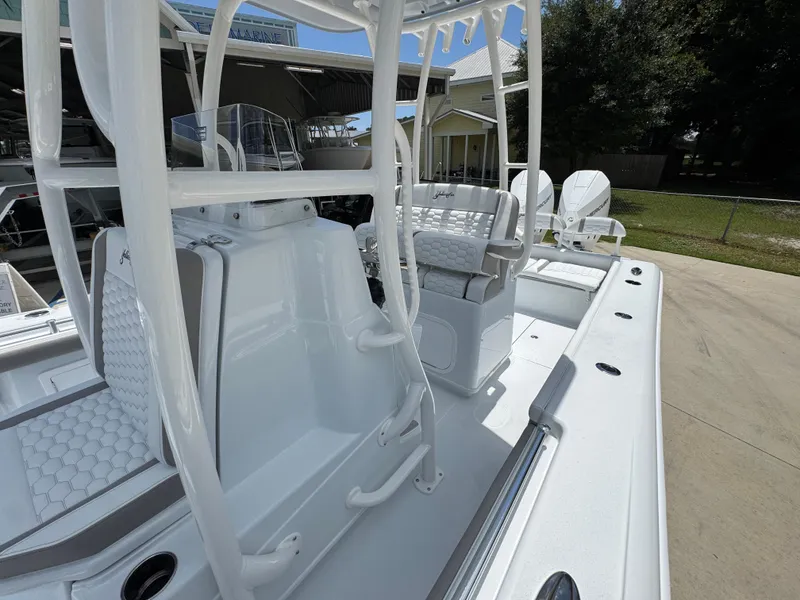 Slide: The Image of 2026 Yellowfin 26 Hybrid boat interior with seating and console, displayed outdoors. - 25