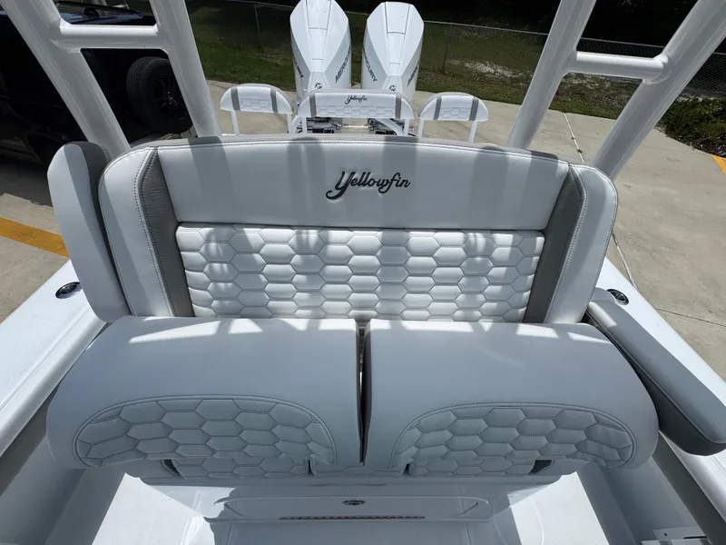 Slide: The Image of 2026 Yellowfin 26 Hybrid boat with luxurious white seating and hexagonal pattern design. - 28