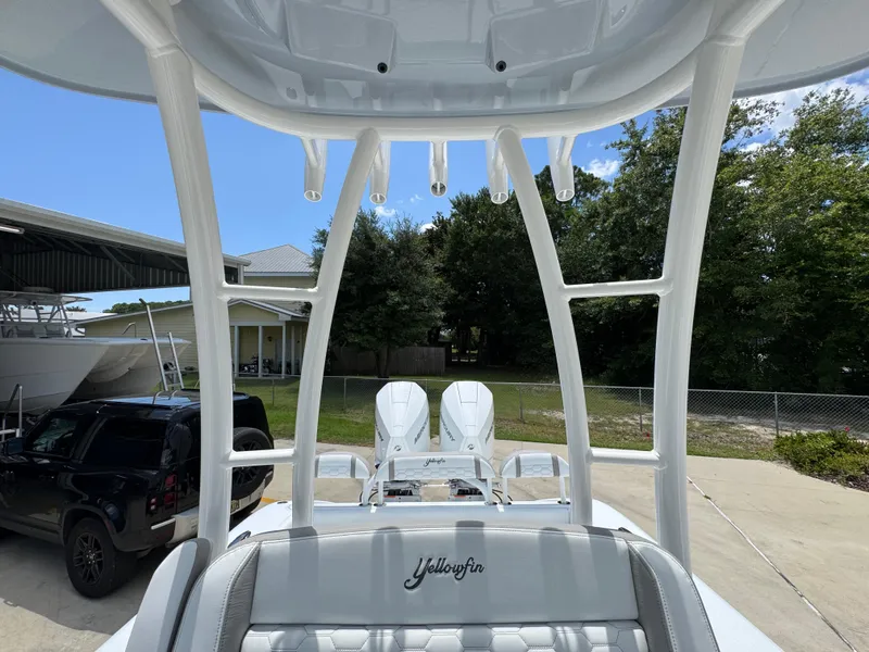 Slide: The Image of 2026 Yellowfin 26 Hybrid boat with sleek design and modern features, docked outdoors. - 29