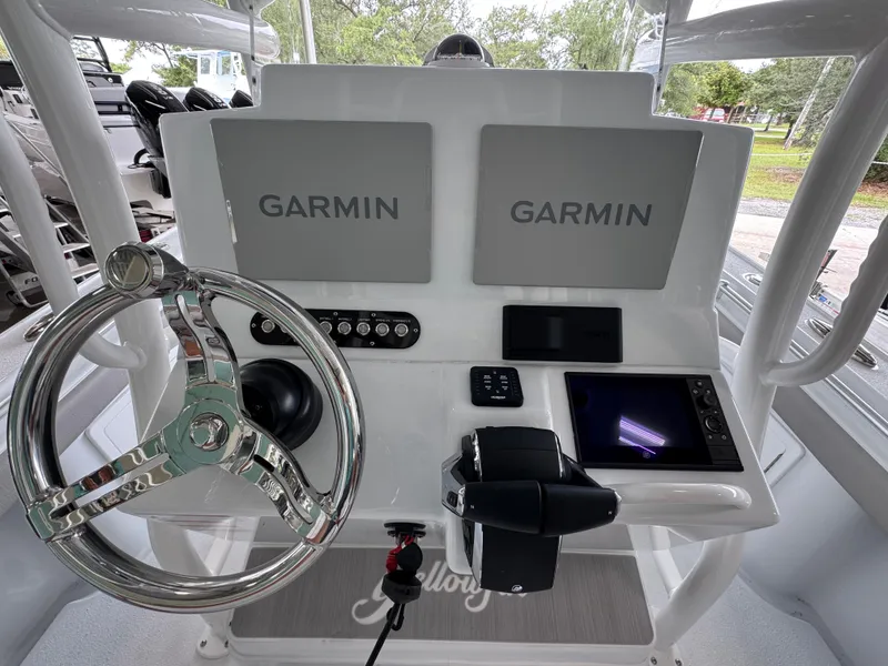 Slide: The Image of Helm of 2026 Yellowfin 26 Hybrid boat with Garmin displays and chrome steering wheel. - 31