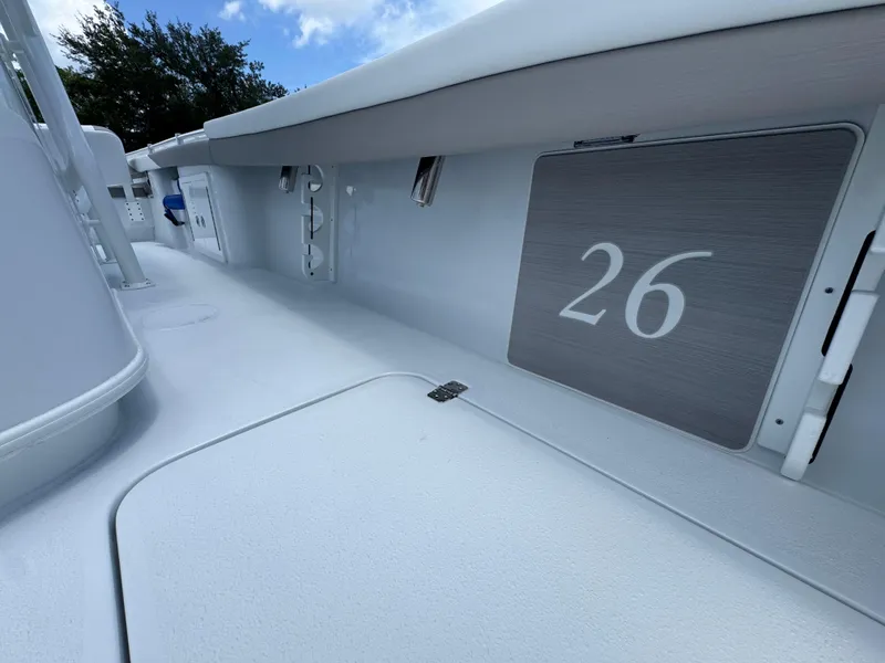 Slide: The Image of 2026 Yellowfin 26 Hybrid boat interior with sleek white design and number 26 displayed. - 34