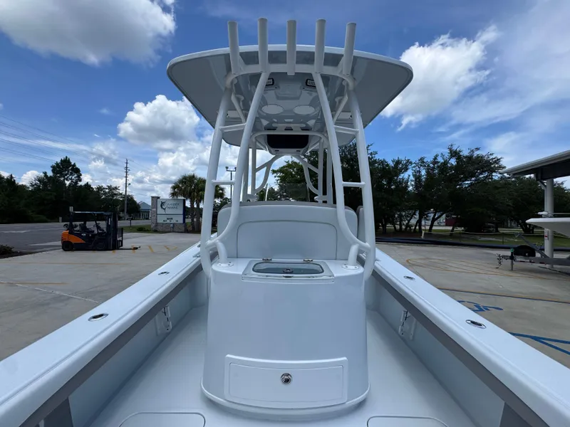 Slide: The Image of 2026 Yellowfin 26 Hybrid boat with T-top, docked under a partly cloudy sky. - 36
