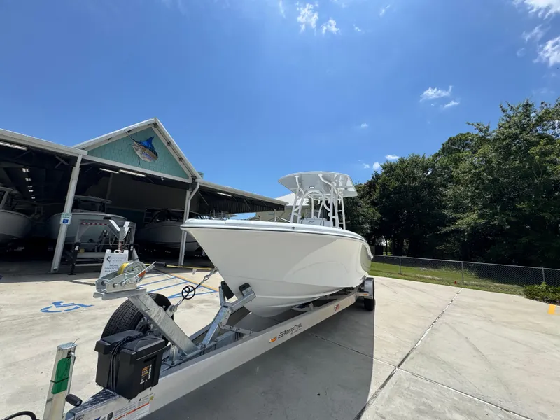 Slide: The Image of 2026 Yellowfin 26 Hybrid boat on trailer under clear blue sky. - 4