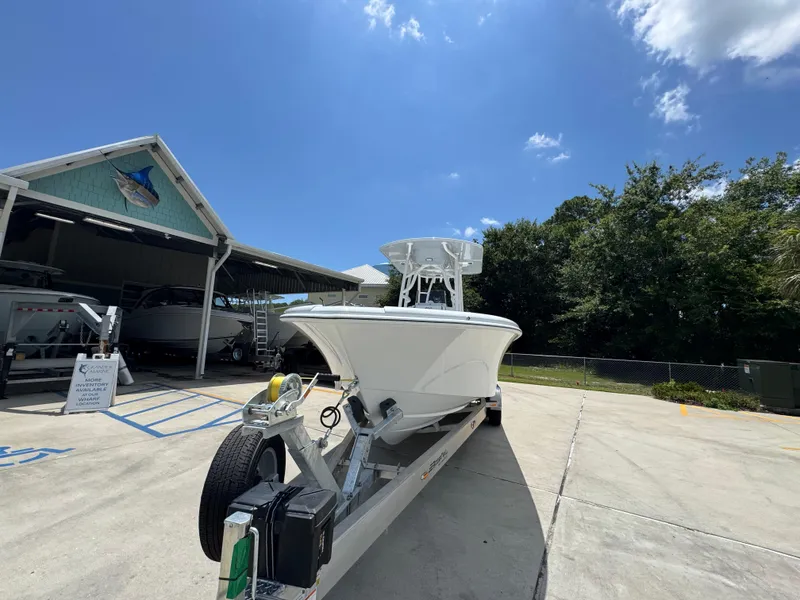 Slide: The Image of 2026 Yellowfin 26 Hybrid boat on trailer under clear blue sky. - 5