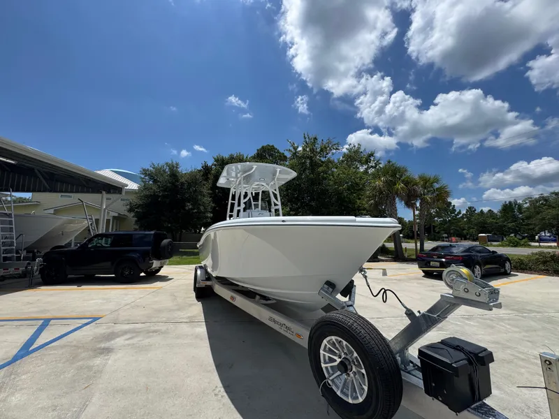 Slide: The Image of 2026 Yellowfin 26 Hybrid boat on trailer under blue sky. - 7