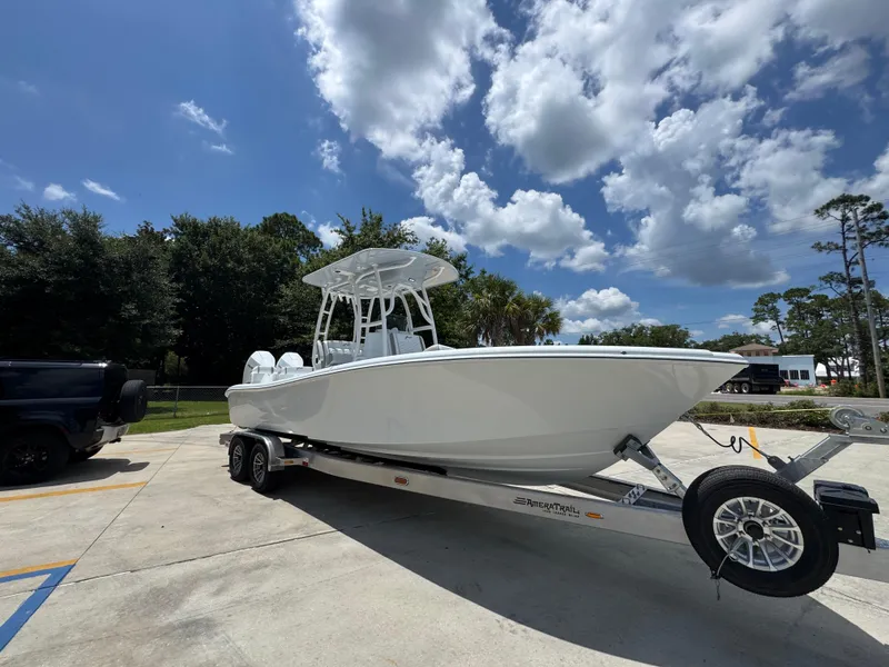 Slide: The Image of 2026 Yellowfin 26 Hybrid boat on trailer under a partly cloudy sky. - 8
