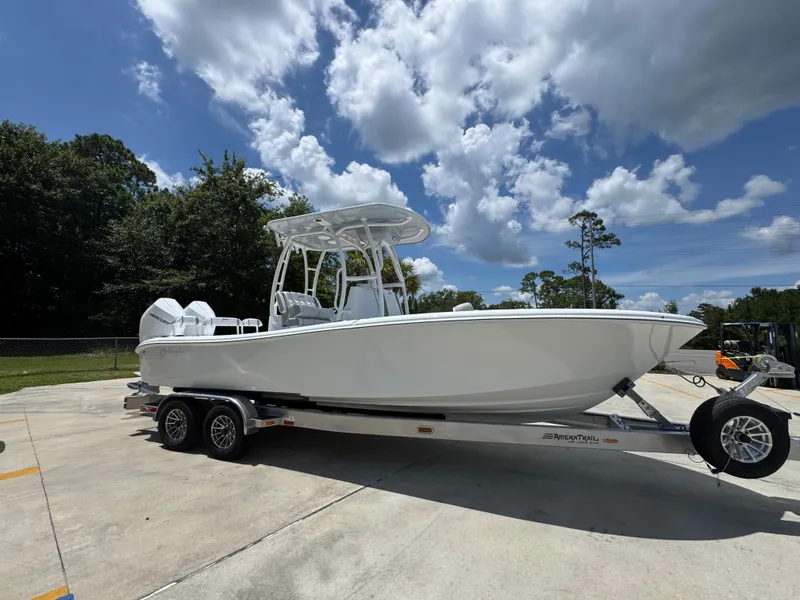 Slide: The Image of 2026 Yellowfin 26 Hybrid boat on trailer under a partly cloudy sky. - 9