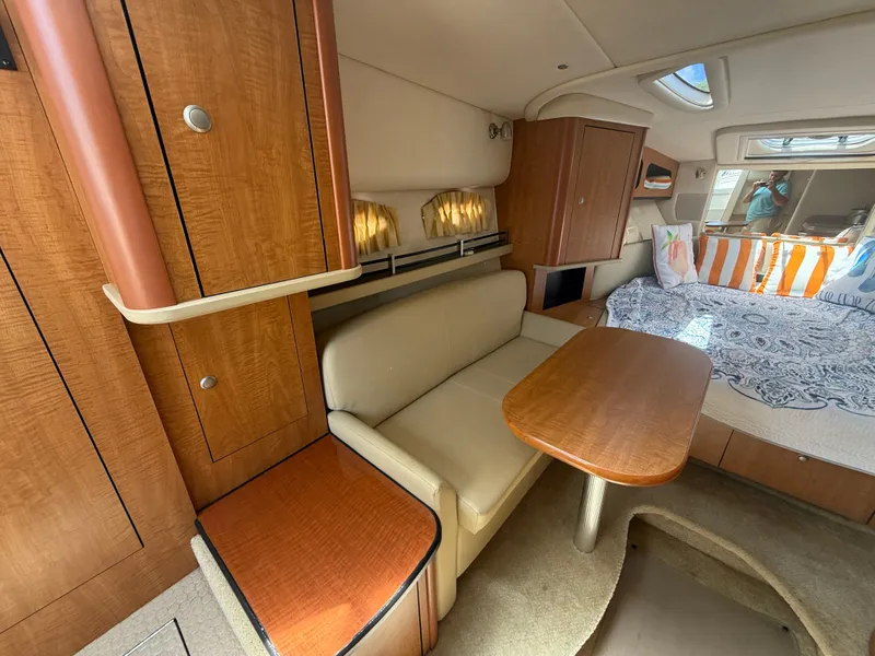 Slide: The Image of Interior of 2006 Sea Ray 290 Sundancer with seating, table, and bed. - 10