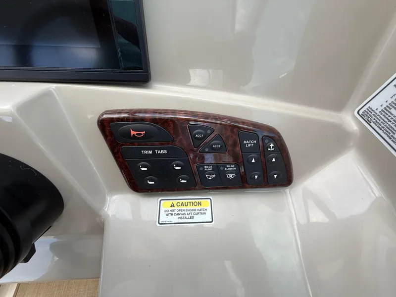 Slide: The Image of Control panel of a 2006 Sea Ray 290 Sundancer boat with various switches. - 15