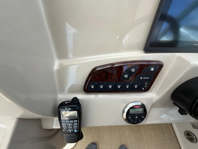 Slide: The Image of Control panel of a 2006 Sea Ray 290 Sundancer boat with radio and switches. - 16