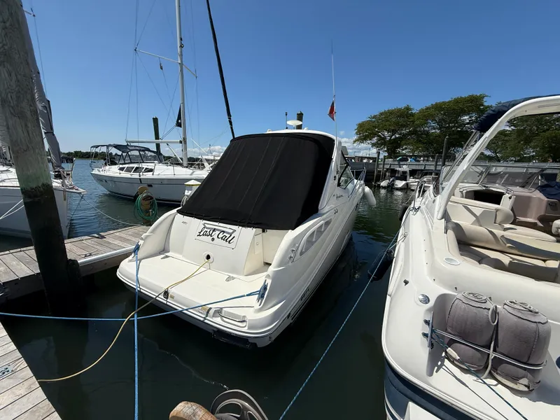 Slide: The Image of 2006 Sea Ray 290 Sundancer docked at marina, sunny day, surrounded by other boats. - 17
