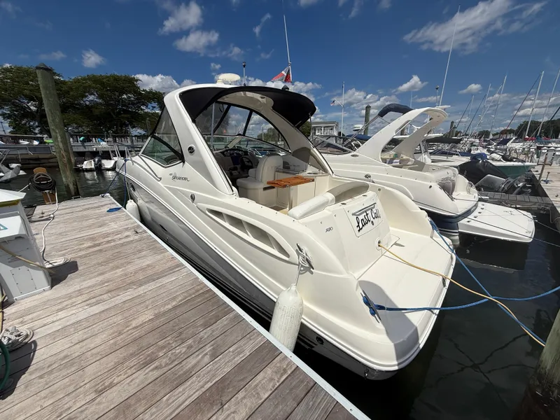 Slide: The Image of 2006 Sea Ray 290 Sundancer docked at marina under blue sky. - 2