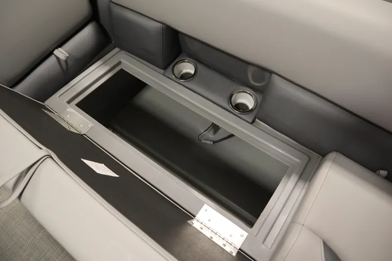 Slide: The Image of 2025 Bentley Pontoons 240 Navigator storage compartment with cup holders and sleek interior design. - 14