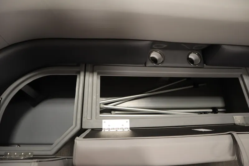 Slide: The Image of 2025 Bentley Pontoons 240 Navigator storage compartment with metal poles inside. - 16