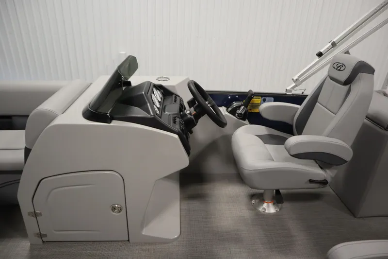 Slide: The Image of 2025 Bentley Pontoons 240 Navigator interior with modern helm and comfortable captain's chair. - 18