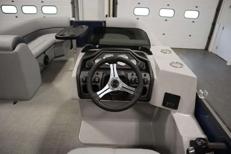 Slide: The Image of 2025 Bentley Pontoons 240 Navigator interior with steering wheel and seating area. - 20