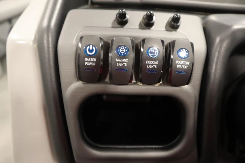 Slide: The Image of Control panel of 2025 Bentley Pontoons 240 Navigator with labeled switches. - 23
