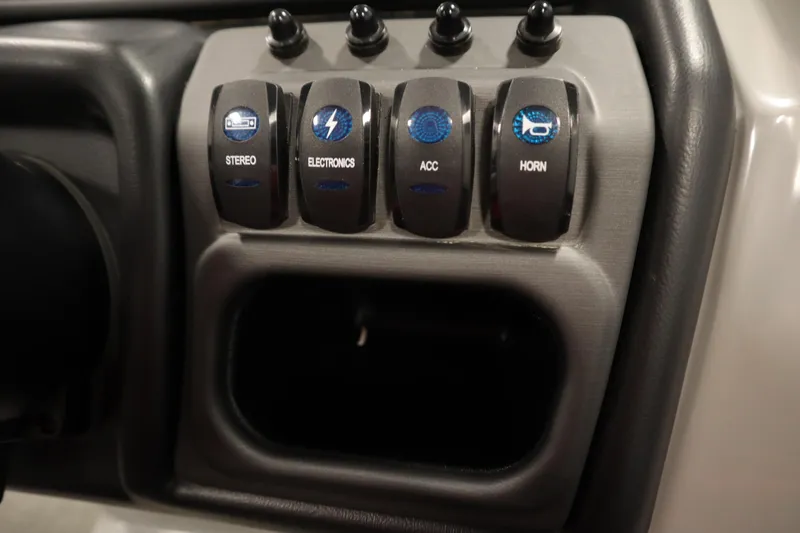 Slide: The Image of Control panel of 2025 Bentley Pontoons 240 Navigator with labeled switches. - 24
