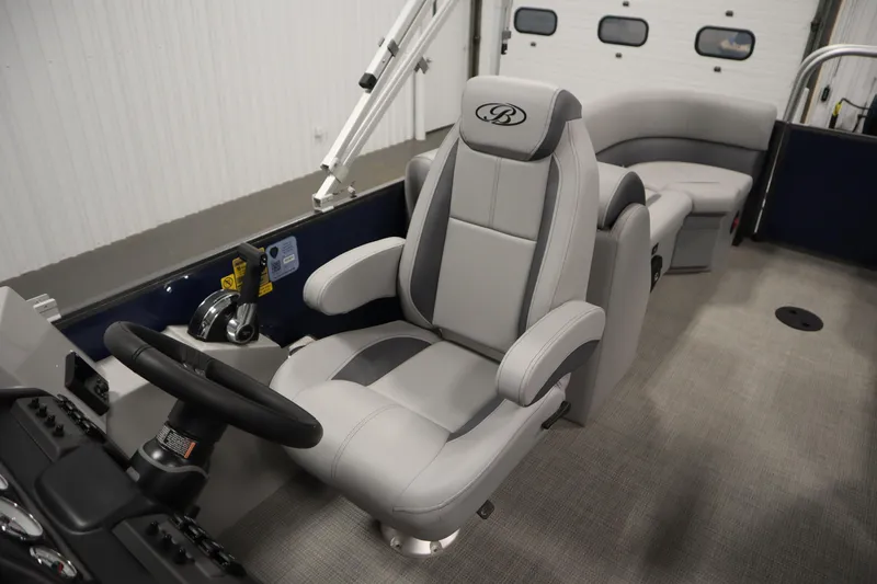 Slide: The Image of 2025 Bentley Pontoons 240 Navigator interior with luxurious captain's chair and steering console. - 28