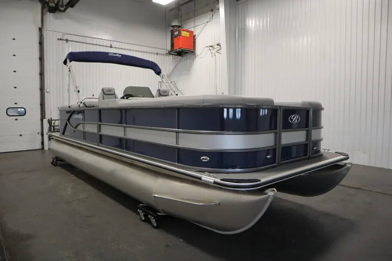 Slide: The Image of 2025 Bentley Pontoons 240 Navigator in a showroom, showcasing sleek design and modern features. - 3