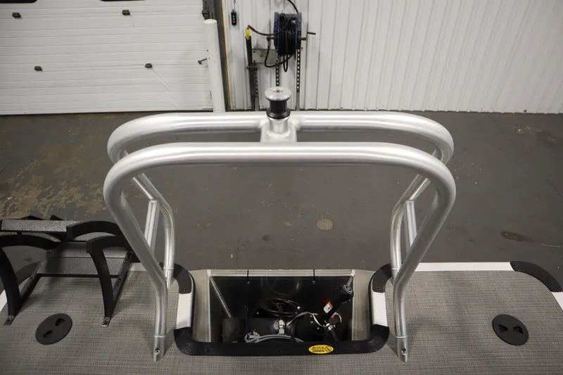 Slide: The Image of 2025 Bentley Pontoons 240 Navigator boat ladder and deck view in a garage setting. - 37