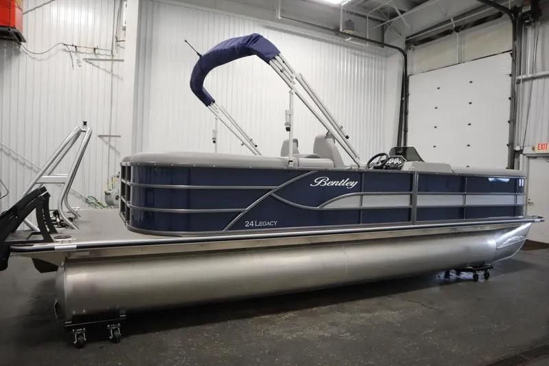 Slide: The Image of 2025 Bentley Pontoons 240 Navigator in a showroom, showcasing sleek design and modern features. - 4