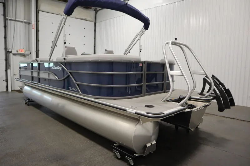 Slide: The Image of 2025 Bentley Pontoons 240 Navigator in a showroom, showcasing sleek design and modern features. - 7