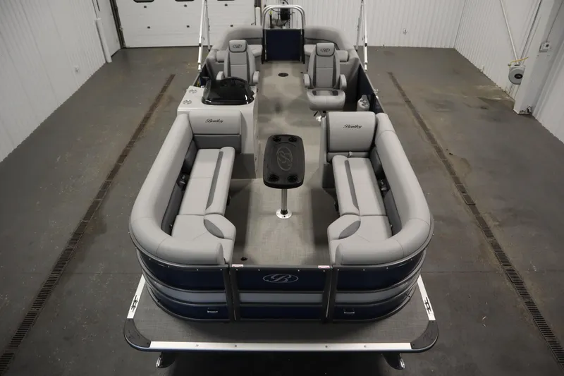 Slide: The Image of 2025 Bentley Pontoons 240 Navigator with spacious seating and modern design in a showroom. - 9