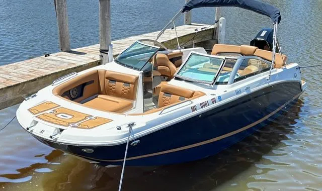 The Image of 2023 Four Winns HD3 boat docked on calm water, featuring sleek design and tan seating. - 0