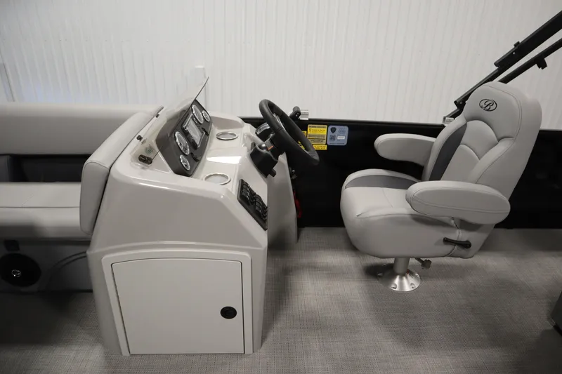 Slide: The Image of 2025 Bentley Pontoons 220 Fish-N-Cruise helm with modern controls and comfortable captain's chair. - 17
