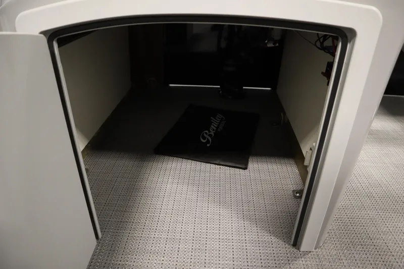 Slide: The Image of 2025 Bentley Pontoons 220 Fish-N-Cruise interior storage compartment with branded mat. - 18
