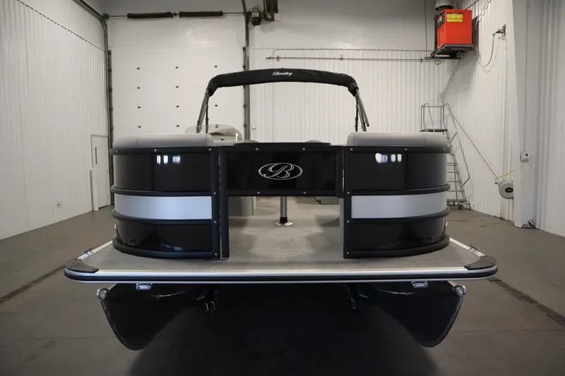 The Image of 2025 Bentley Pontoons 220 Fish-N-Cruise in showroom, sleek design, black and silver finish. - 2