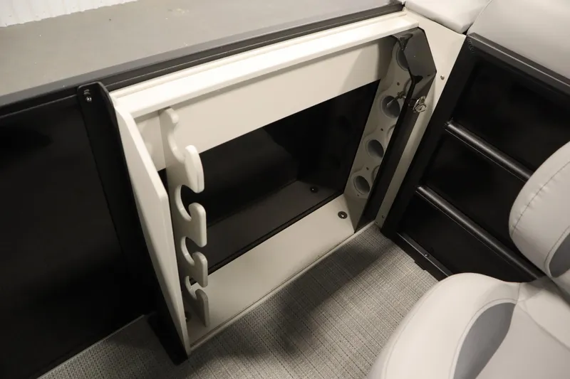 Slide: The Image of 2025 Bentley Pontoons 220 Fish-N-Cruise storage compartments with keys on a sleek black finish. - 35
