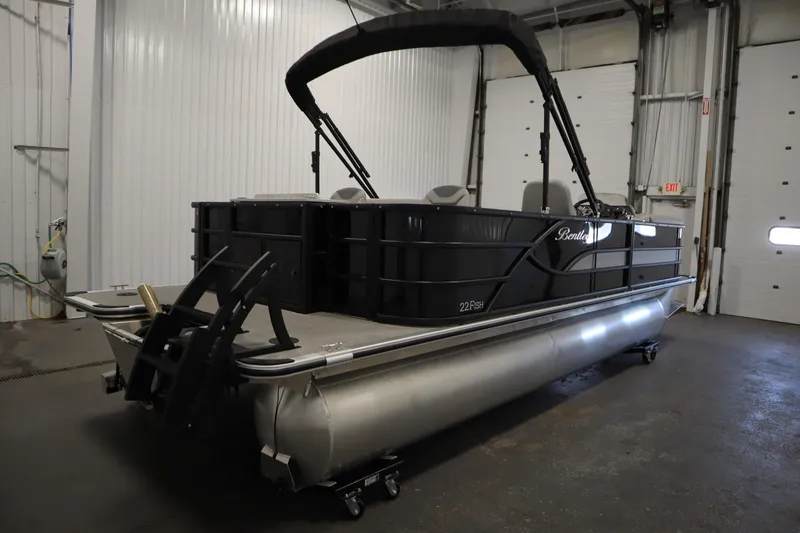 Slide: The Image of 2025 Bentley Pontoons 220 Fish-N-Cruise in showroom, sleek black and silver design. - 5
