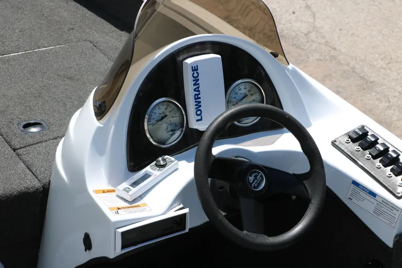 Slide: The Image of 2018 Polar Kraft Bass America TX175 Pro Bass boat dashboard with steering wheel and gauges. - 12