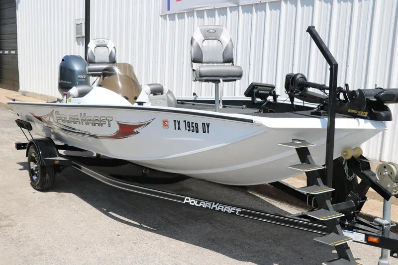 Slide: The Image of 2018 Polar Kraft Bass America TX175 Pro Bass boat on trailer, white exterior, parked outdoors. - 4