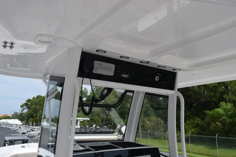 Slide: The Image of 2026 Sea Hunt Gamefish 30 Forward Seating boat interior with electronic equipment and sleek design. - 10