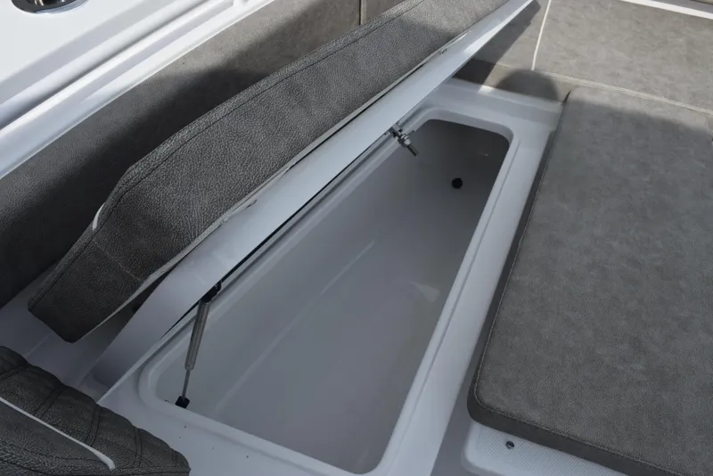 Slide: The Image of 2026 Sea Hunt Gamefish 30 Forward Seating storage compartment with open cushioned lid. - 15