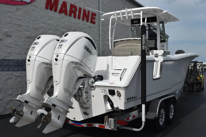 Slide: The Image of 2026 Sea Hunt Gamefish 30 boat with twin Yamaha engines, parked on a trailer. - 3