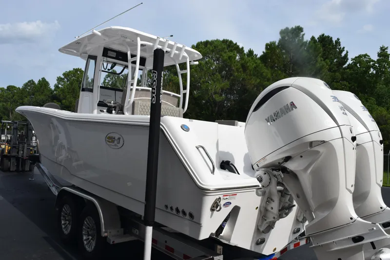 Slide: The Image of 2026 Sea Hunt Gamefish 30 boat with dual Yamaha engines on a trailer. - 5