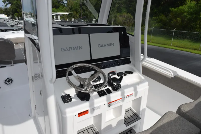 Slide: The Image of 2026 Sea Hunt Gamefish 30 helm with dual Garmin displays and steering wheel. - 9