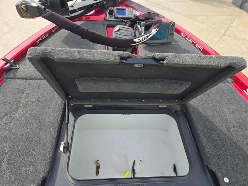 Slide: The Image of Open storage compartment on 2014 Skeeter ZX 190 boat with fishing gear inside. - 12