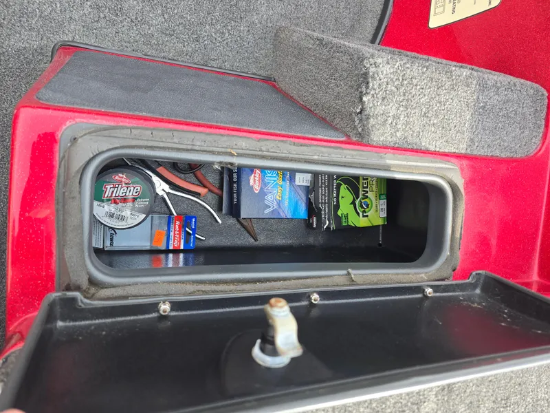Slide: The Image of Storage compartment in a 2014 Skeeter ZX 190 boat with fishing gear and tools. - 13