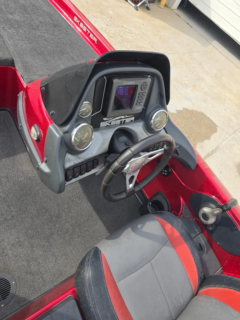 Slide: The Image of 2014 Skeeter ZX 190 boat dashboard with steering wheel and control panel. - 14