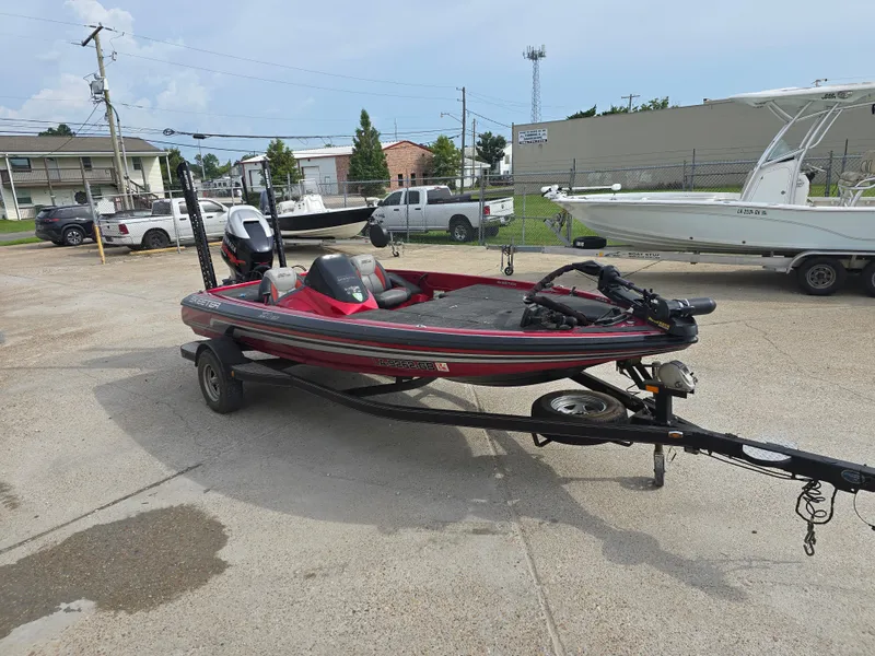 Slide: The Image of 2014 Skeeter ZX 190 bass boat on trailer in a parking lot. - 2