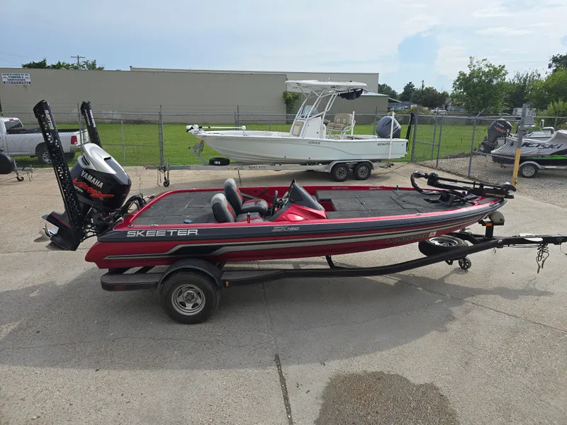 Slide: The Image of 2014 Skeeter ZX 190 boat on trailer with Yamaha motor, parked outdoors. - 3